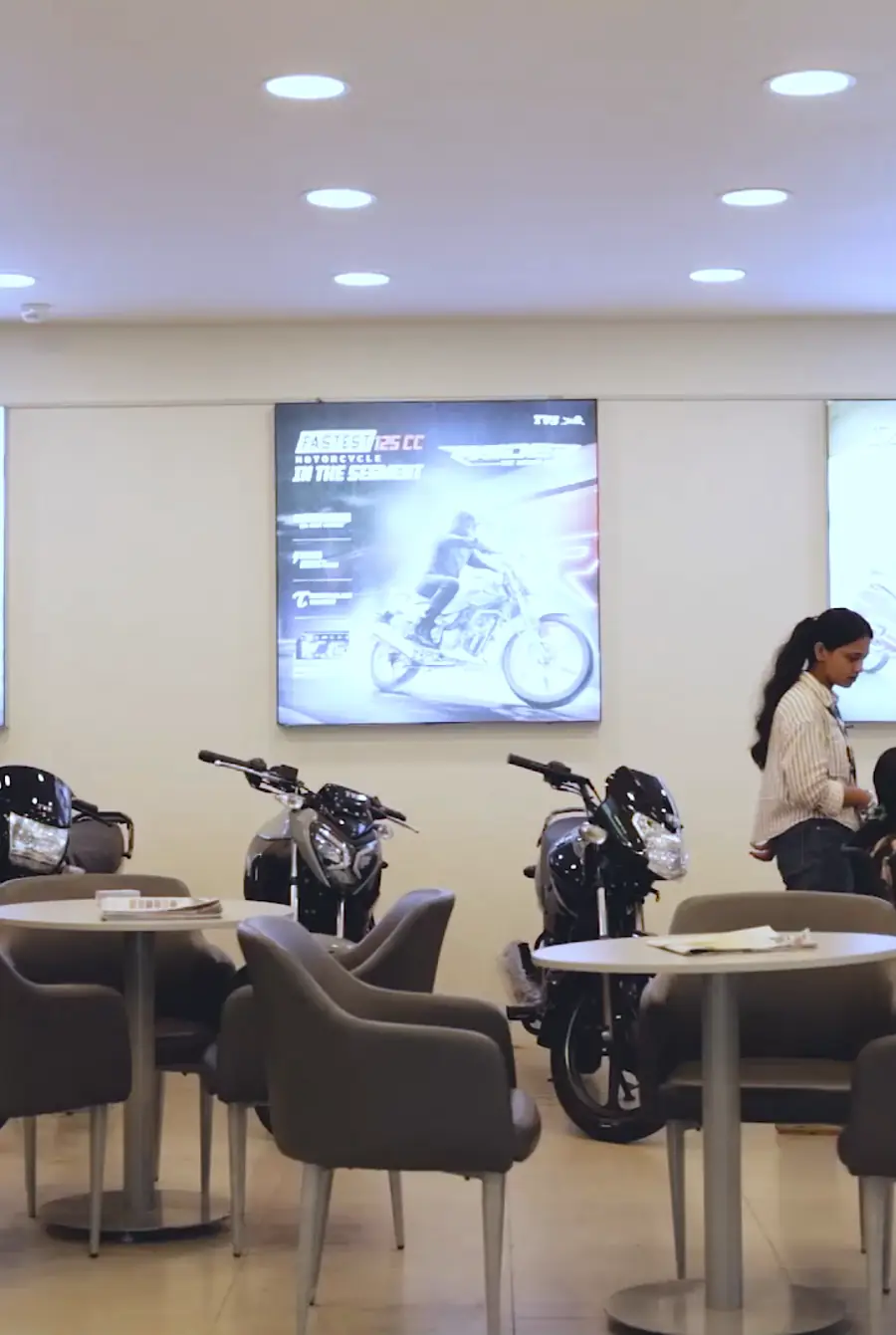 TVS scooters on display inside the SG TVS showroom